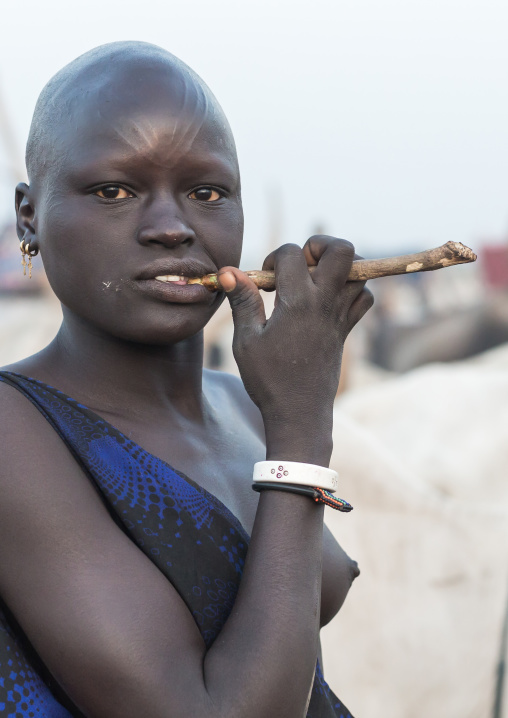 Mundari tribe woman using a wooden toothbrush, Central Equatoria, Terekeka, South Sudan