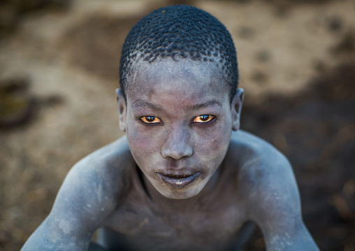 Portrait of a Mundari tribe boy covered in ash to repel flies and mosquitoes in a cattle camp, Central Equatoria, Terekeka, South Sudan