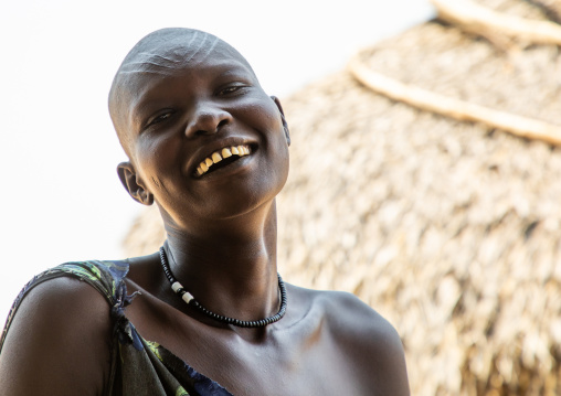 Portrait of a smiling Mundari tribe woman with scarifications on the forehead, Central Equatoria, Terekeka, South Sudan