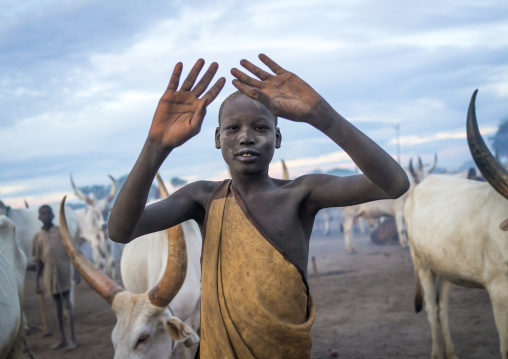 A Mundari tribe boy mimics the position of horns of his favourite cow, Central Equatoria, Terekeka, South Sudan