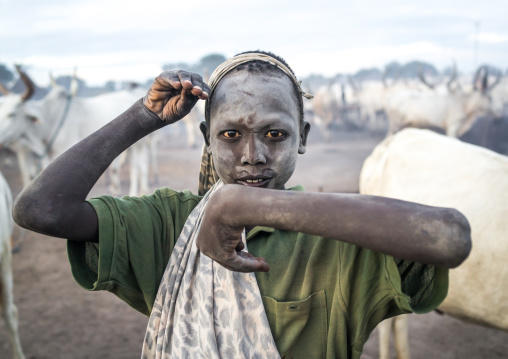 A Mundari tribe boy mimics the position of horns of his favourite cow, Central Equatoria, Terekeka, South Sudan