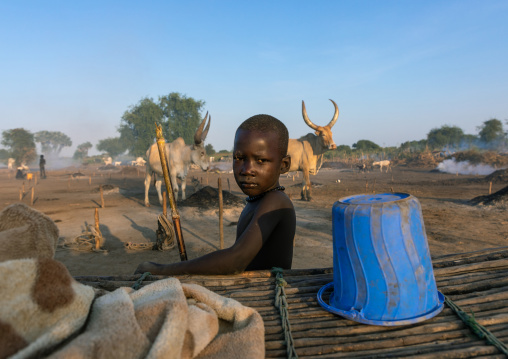 Mundari tribe boy taking care of the long horns cows in the camp, Central Equatoria, Terekeka, South Sudan