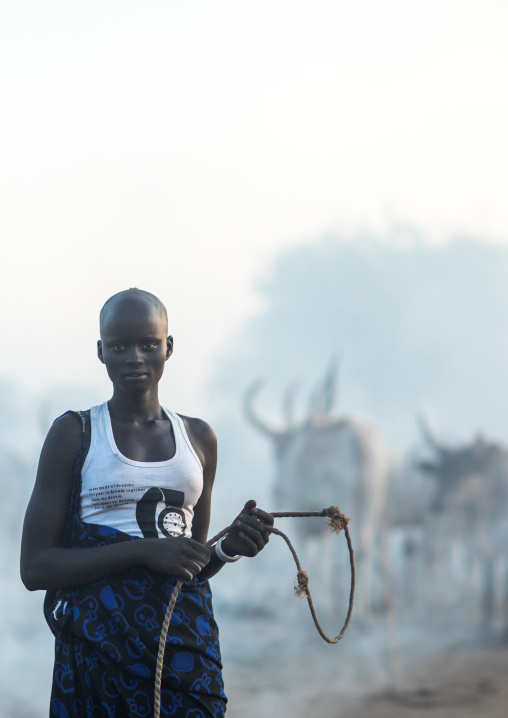 Mundari tribe woman with long horns cows in a camp, Central Equatoria, Terekeka, South Sudan