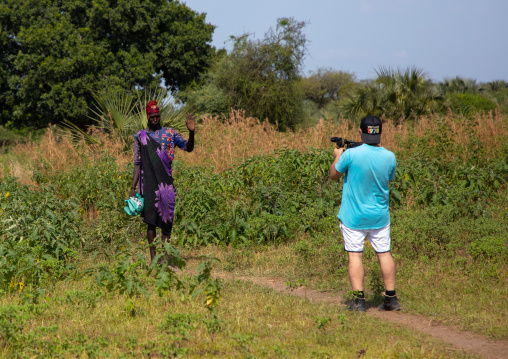 Tourist taking pictures of a Mundari tribe man, Central Equatoria, Terekeka, South Sudan