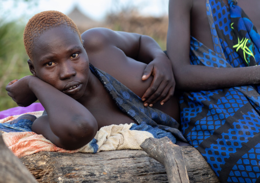 Portrait of a Mundari tribe women resting on a bed, Central Equatoria, Terekeka, South Sudan