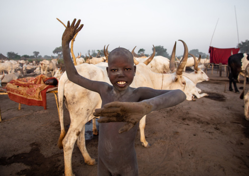 A Mundari tribe boy mimics the position of horns of his favourite cow, Central Equatoria, Terekeka, South Sudan