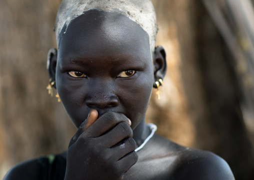 Portrait of a beautiful Mundari young woman with ash on the head to dye her hair in red, Central Equatoria, Terekeka, South Sudan
