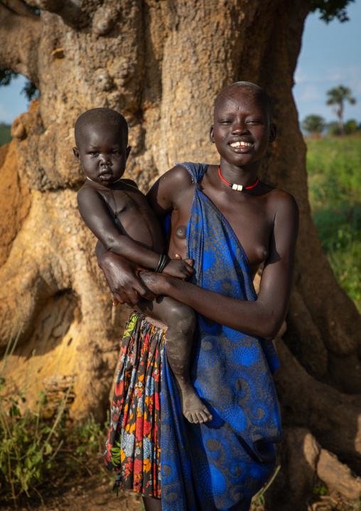 Portrait of a Mundari tribe young woman with a child, Central Equatoria, Terekeka, South Sudan