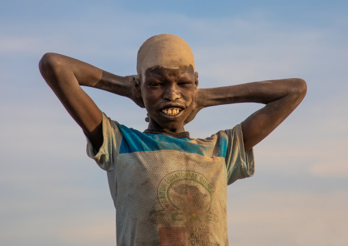 Mundari tribe boy covering his face in ash to protect from the mosquitoes and flies bites, Central Equatoria, Terekeka, South Sudan