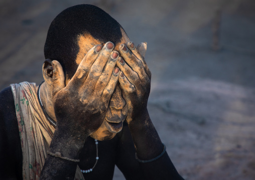Mundari tribe man covering his body in ash to repel flies and mosquitoes, Central Equatoria, Terekeka, South Sudan