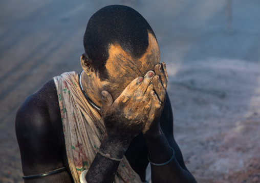 Mundari tribe man covering his body in ash to repel flies and mosquitoes, Central Equatoria, Terekeka, South Sudan