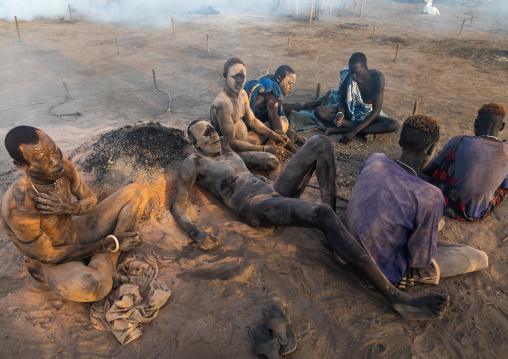 Mundari tribe men covering their bodies in ash to protect from the mosquitoes and flies bites, Central Equatoria, Terekeka, South Sudan