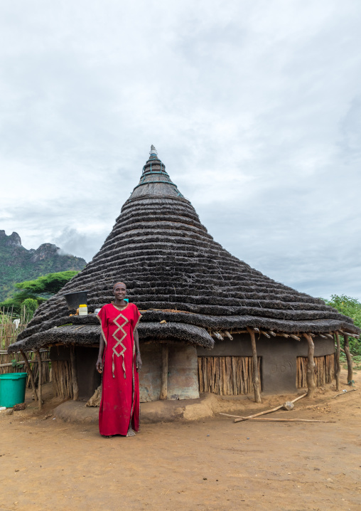Larim tribe woman in front of her traditional house, Boya Mountains, Imatong, South Sudan
