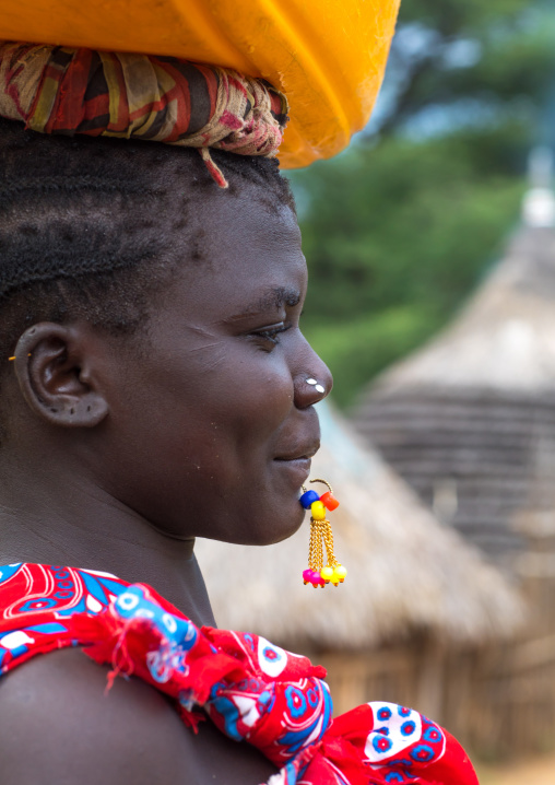 Portrait of a Larim tribe woman carrying a yellow jerrican on the head, Boya Mountains, Imatong, South Sudan