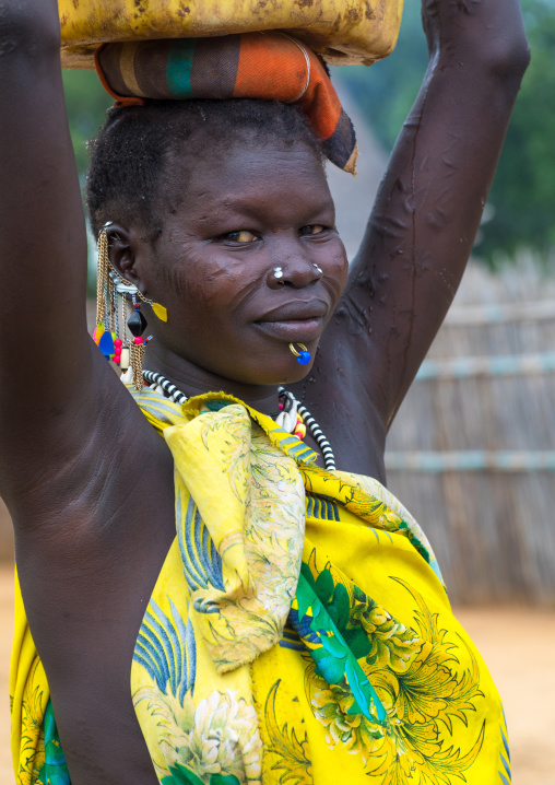 Portrait of a Larim tribe woman carrying a yellow jerrican on the head, Boya Mountains, Imatong, South Sudan