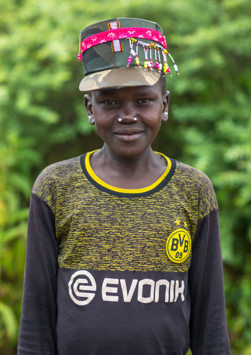 Larim tribe boy waering a dortmund football shirt and with scarifications on the cheek, Boya Mountains, Imatong, South Sudan