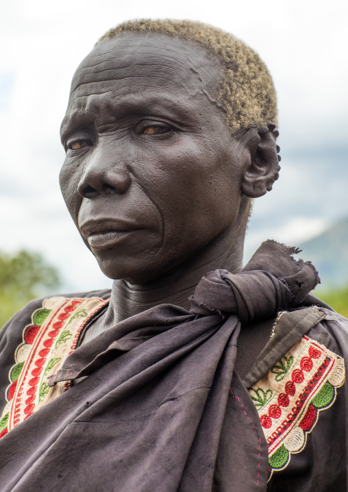 Lotuko tribe old woman with the ears cut in the same way they do to their cows as decoration, Central Equatoria, Illeu, South Sudan
