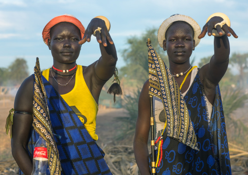 Mundari tribe women mimic the position of horns of their favourite cows, Central Equatoria, Terekeka, South Sudan