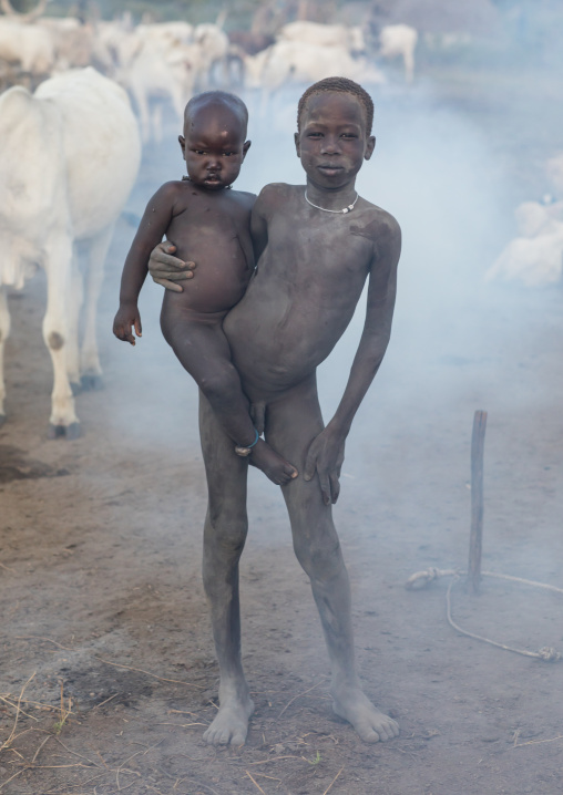Mundari tribe boys covered in ash taking care of long horns cows in a camp, Central Equatoria, Terekeka, South Sudan
