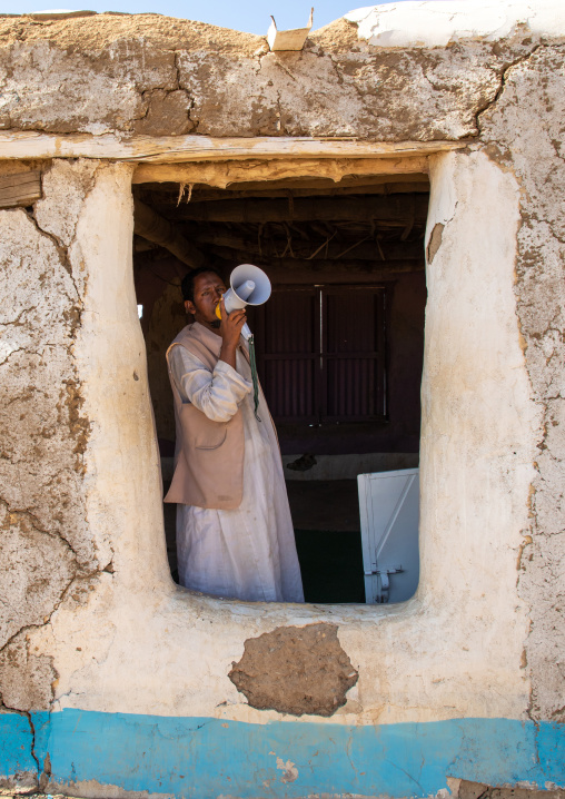Muezzin making the call to prayers in a small mosque with a megaphone, Kassala State, Kassala, Sudan