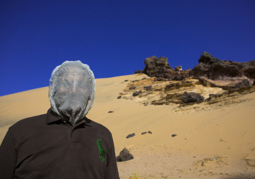 Sudan, Northern Province, Jabal Tushka, man wearing a net as a protection against the flies