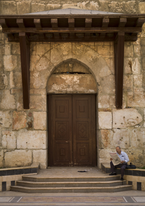 Man Reading Near An Old Door, Damascus, Damascus Governorate, Syria