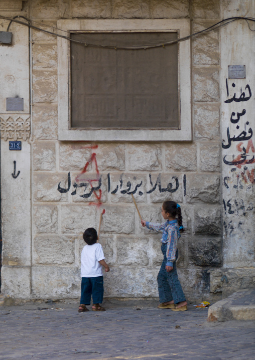 Kid Learning To Read Arabic In The Street, Aleppo, Aleppo Governorate, Syria