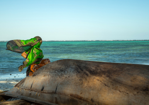 Tanzania, Zanzibar, Kizimkazi, veiled muslim woman looking away at the sea