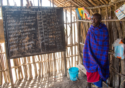Tanzania, Ashura region, Ngorongoro Conservation Area, maasai teacher inside a school