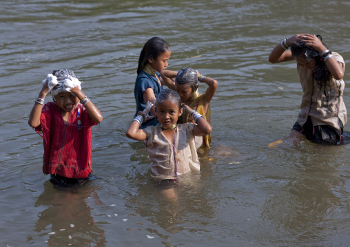 Long neck children having bath in river in nam peang din village, North thailand