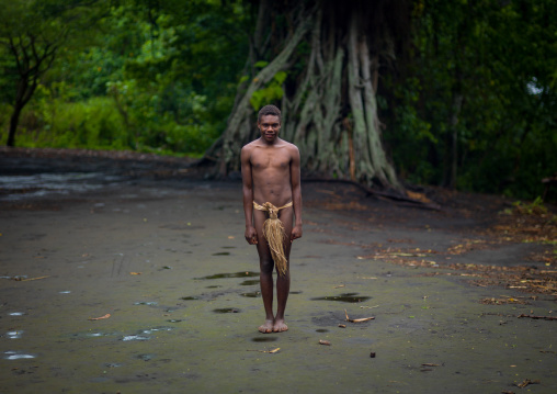 Teenager wearing a penis sheath called a namba standing in the middle of the ceremonial square, Tanna island, Yakel, Vanuatu
