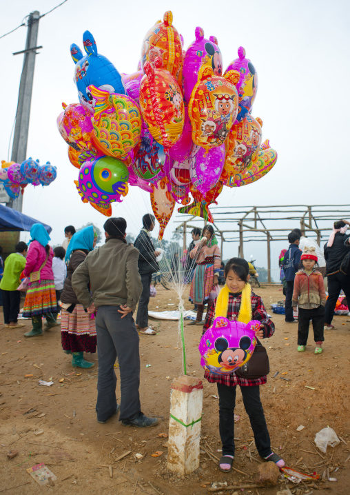 Girl selling balloons on a marketplace, Sapa, Vietnam