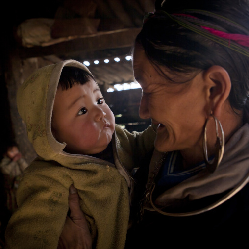 Black hmong grandmother with her grandson in the arms, Sapa, Vietnam