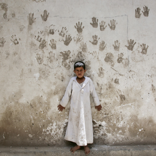 Child In Front Of A Wall Covered With Handprints To Protect From The Evil Eye, Sanaa, Yemen