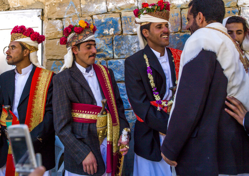 Grooms with turbans decorated with flowers during a wedding, Amran Governorate, Thula, Yemen