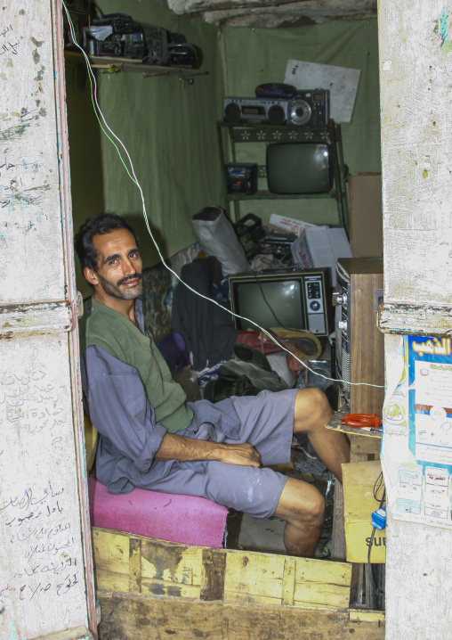 Yemeni man selling old televisions, Ibb Governorate, Jibla, Yemen