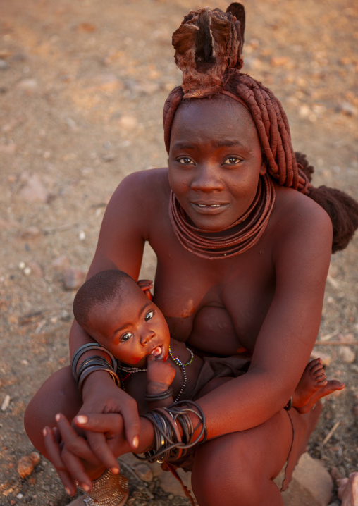Himba woman with her baby, Kunene region, Epupa, Namibia