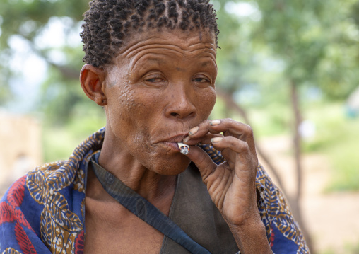 Bushman woman smoking, Otjozondjupa, Tsumkwe, Namibia