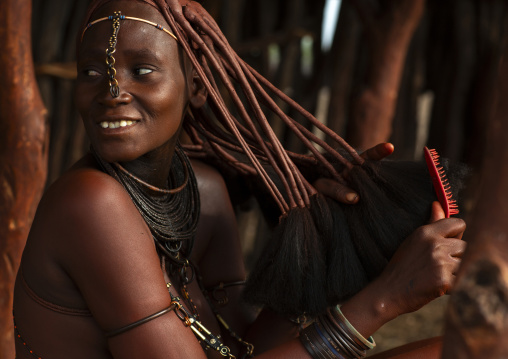 Himba woman taking care of her hair, Kunene region, Epupa, Namibia