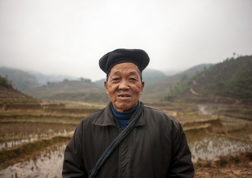 Old black Hmong man with a beret in front of paddy fields, Lao Cai province, Sapa, Vietnam