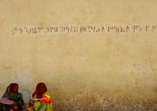 Eritrean women sit in the street, Debub, Senafe, Eritrea