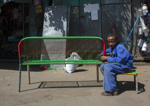 Eritrean boy making a bench in medebar metal market, Central Region, Asmara, Eritrea