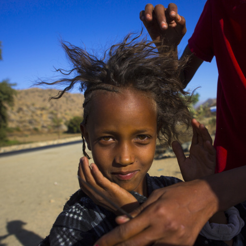 Bilen tribe girl having a haircut, Anseba, Keren, Eritrea
