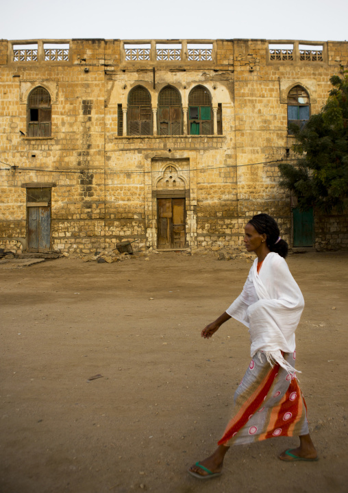 Eritrean passing in front of an ottoman house, Northern Red Sea, Massawa, Eritrea