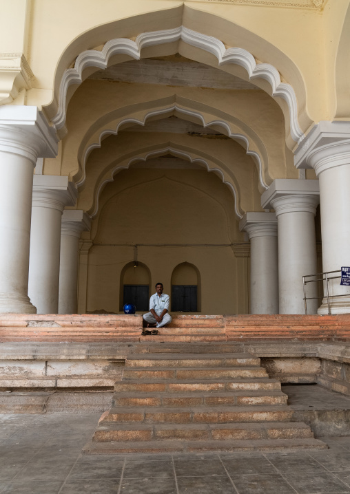 Man sit in the Pillared hall of Thirumalai Nayakar Palace, Tamil Nadu, Madurai, India