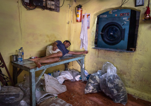 Laundry Worker sleeping in Dhobi Ghat, Maharashtra state, Mumbai, India