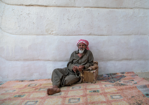 Old man resting in front of his house, Najran Province, Najran, Saudi Arabia