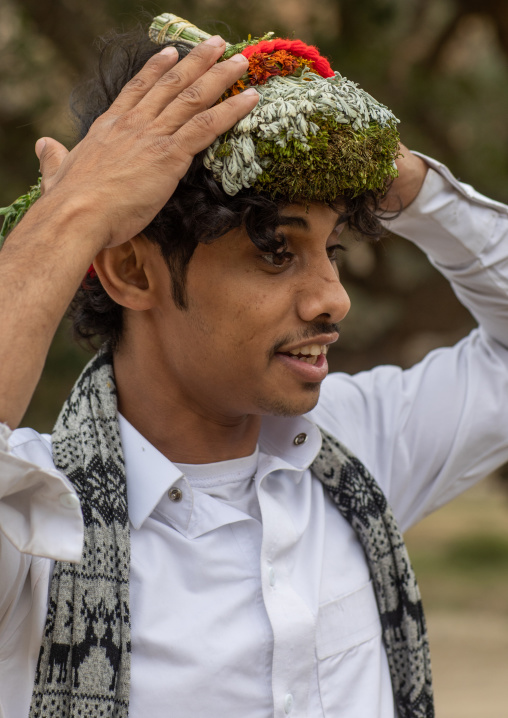 Portrait of a flower man wearing a floral crown on the head, Asir province, Sarat Abidah, Saudi Arabia