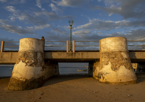 Girl on the jetty at sunset, Nampula Province, Island of Mozambique, Mozambique