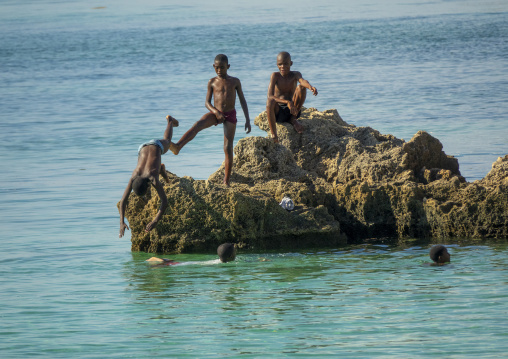 Boys diving in the sea from rocks, Nampula Province, Island of Mozambique, Mozambique